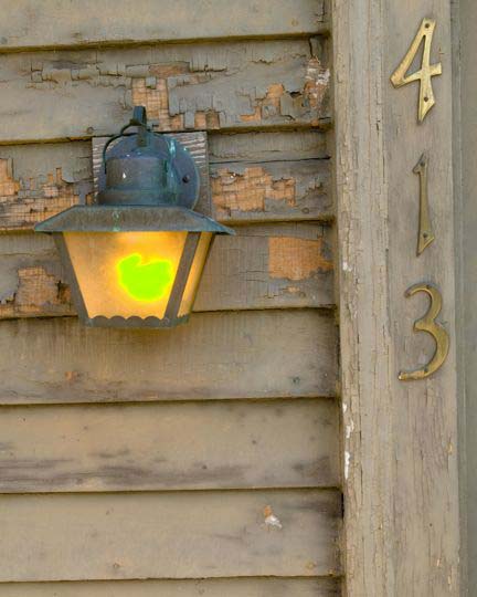 Minneapolis Victorian home restoration project completed by William Nunn Painting included restoring vintage outdoor lighting