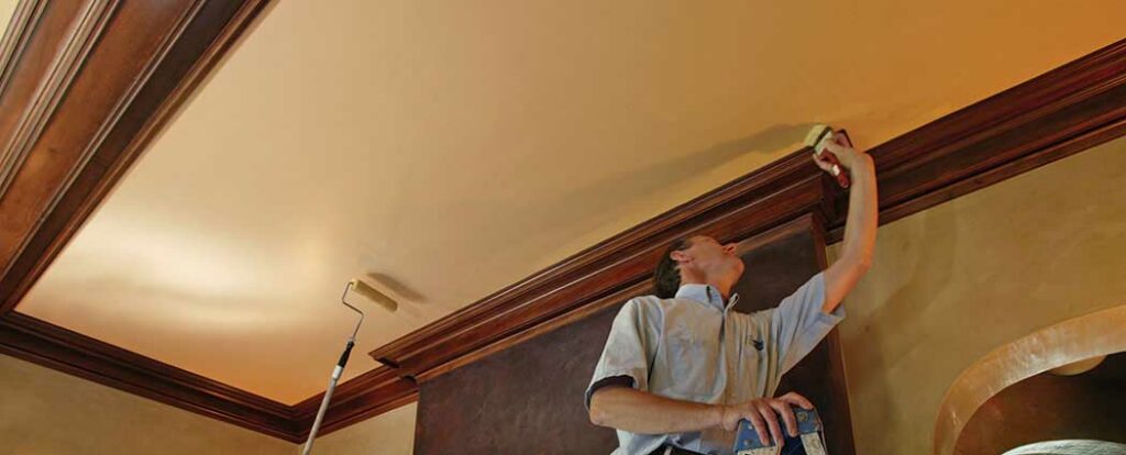 Interior painting specialists painting a ceiling