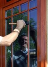 Renewing the varnish on the exterior windows of this Lake of the Isles home