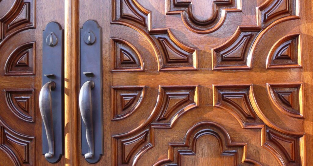 Wood Finishing on elegantly carved door makes the front entrance most welcoming